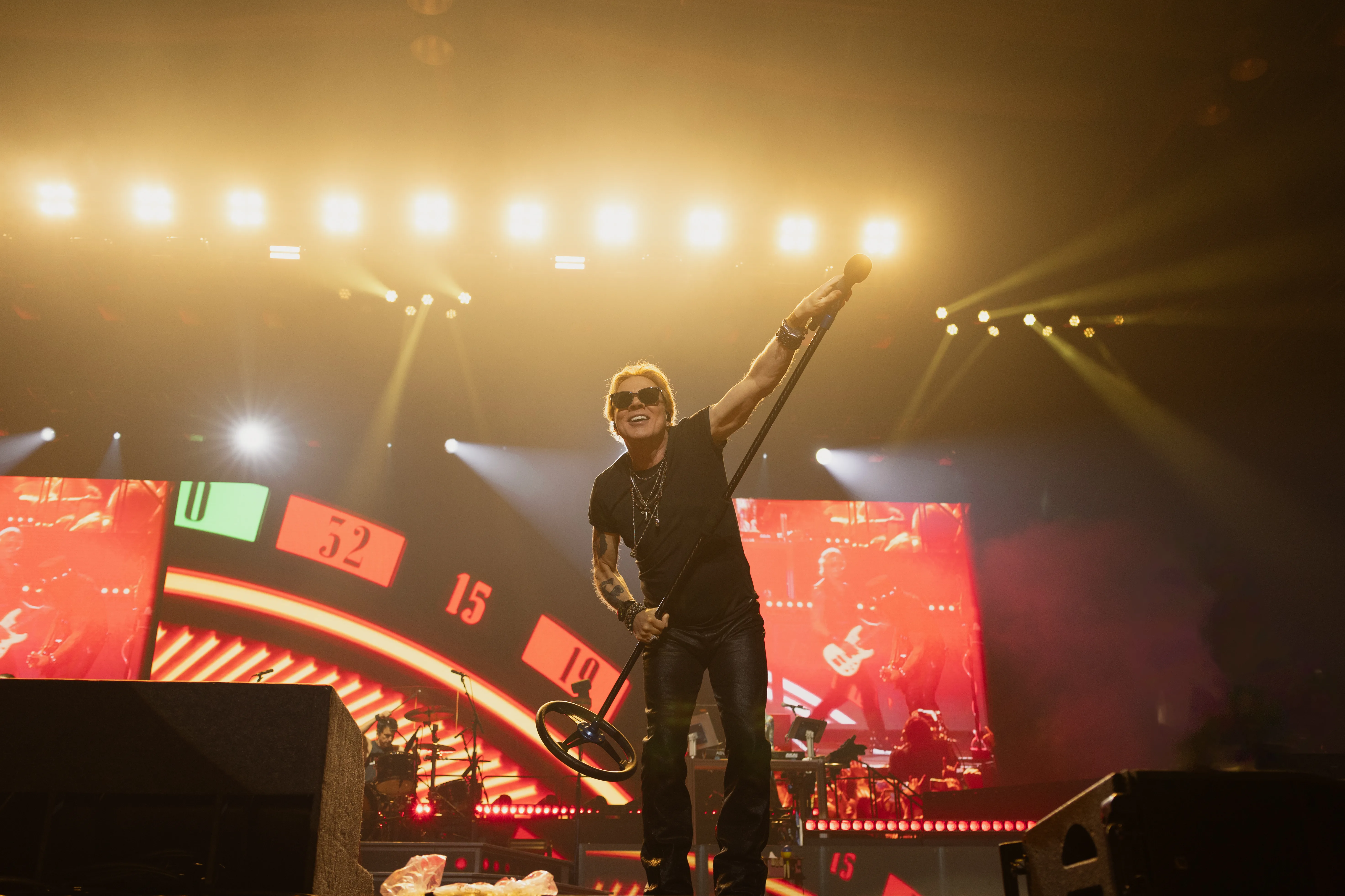 Axl Rose performing on stage in Bangkok during a live concert.