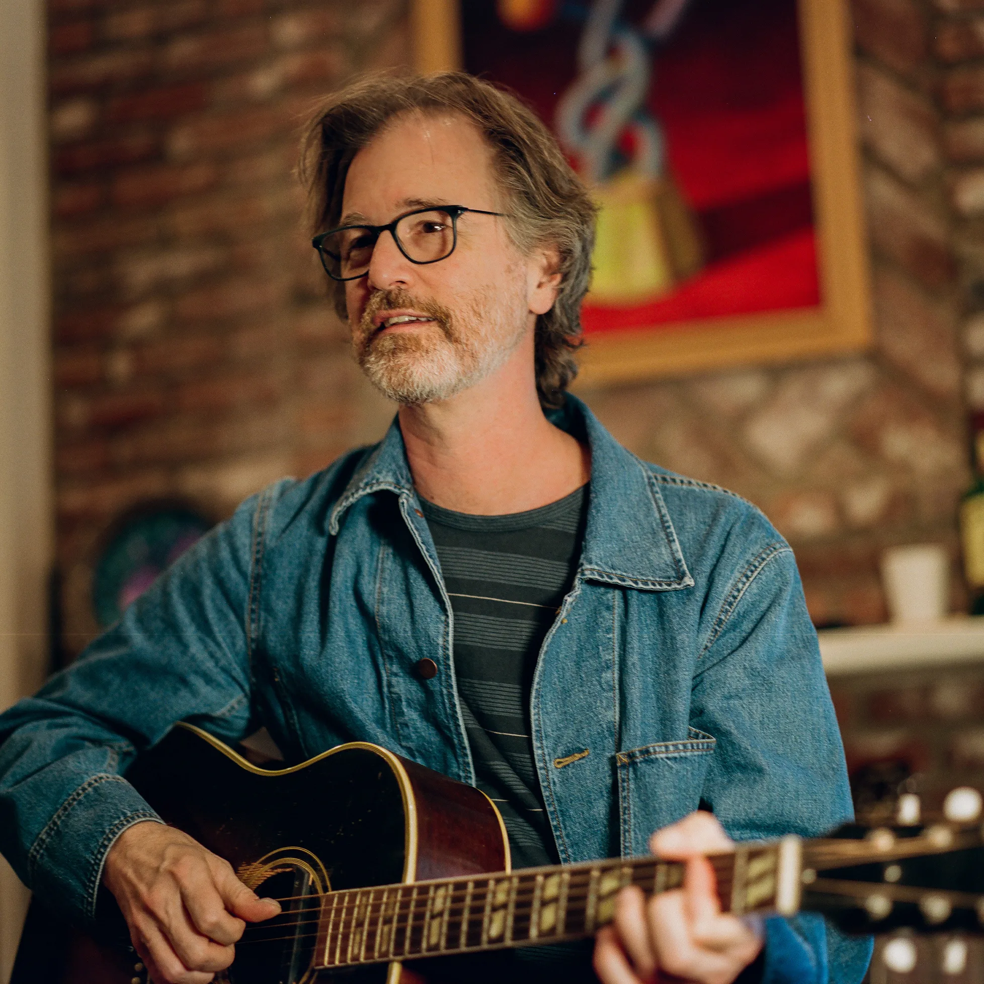 Dan Wilson playing acoustic guitar.