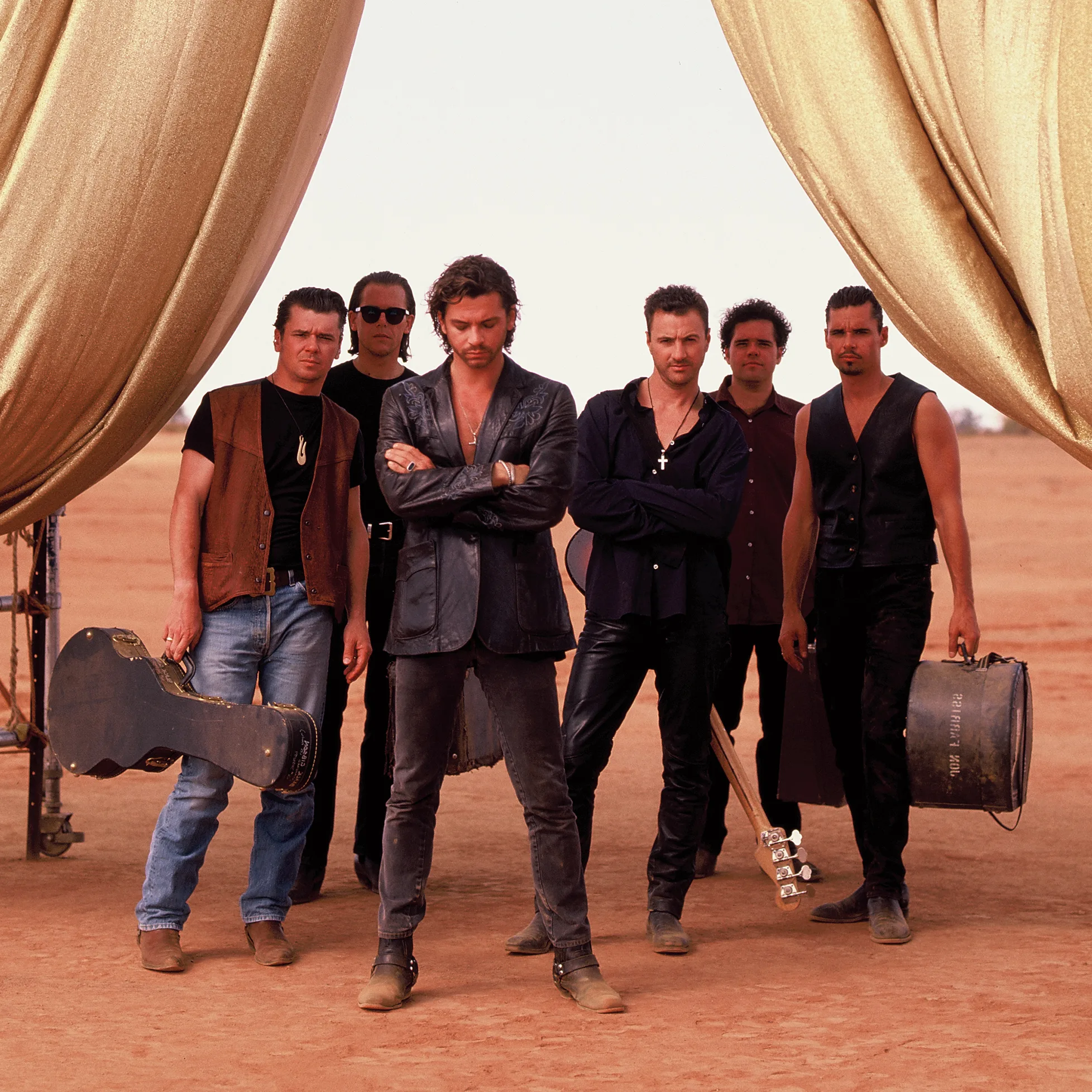 INXS group photo with golden curtains.