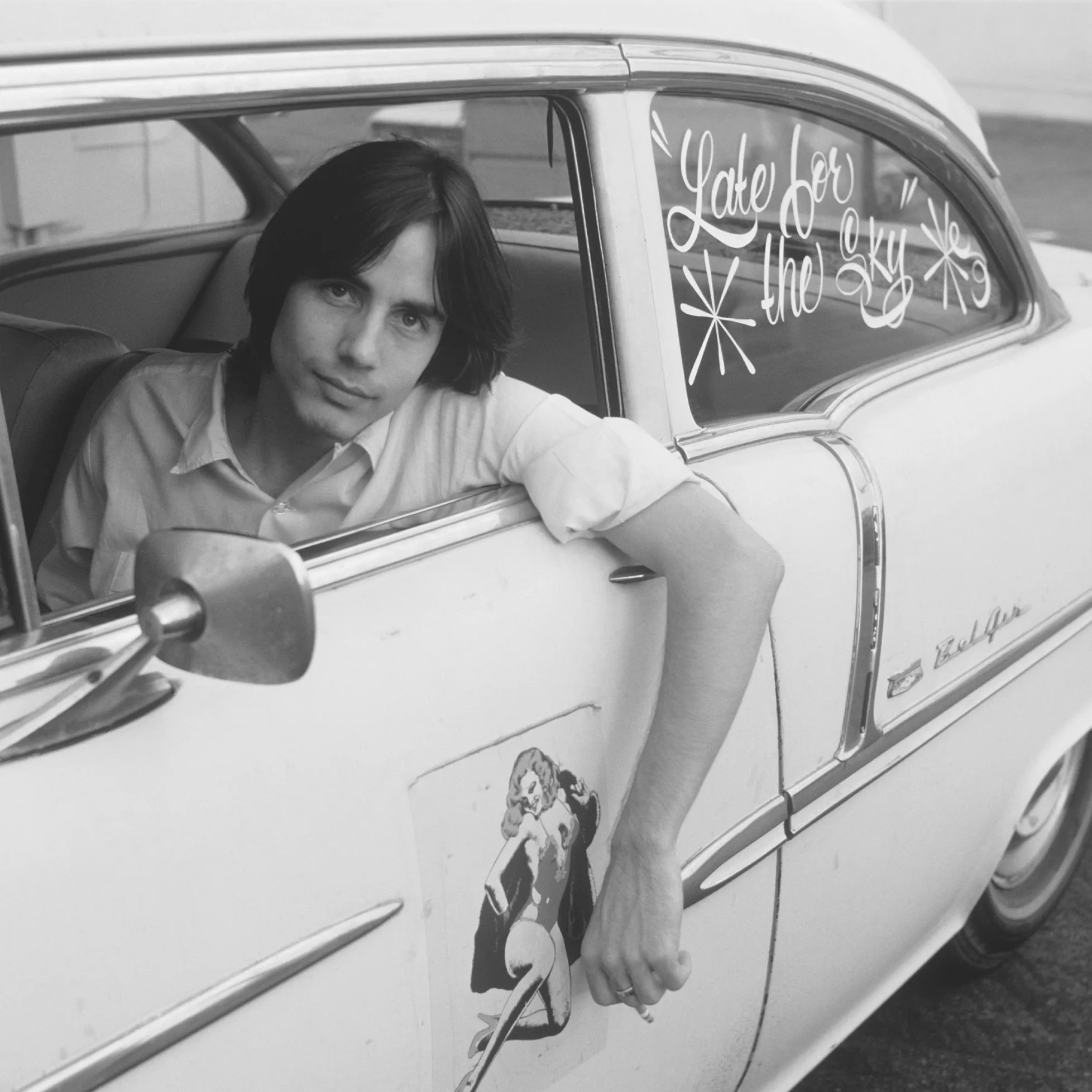 Jackson Browne leaning from a vintage white car with "Late for the Sky" on the window.